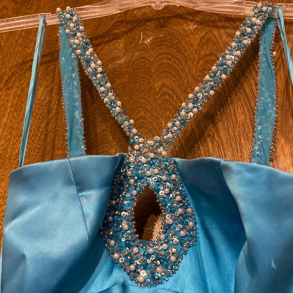 Formal gown. Has beading all the way around the straps.